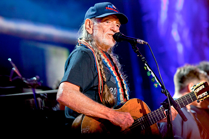 Color Photograph by Willa Stein of Willie Nelson performing on stage at Farm Aid in Raleigh, NC