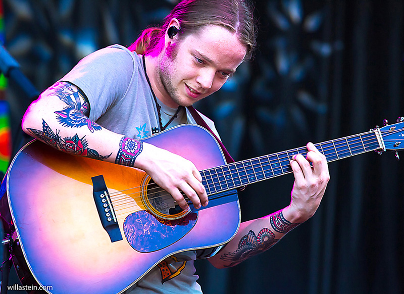 Color Photograph by Willa Stein of Billy Strings playing guitar on stage at Roosterwalk music festival in VA