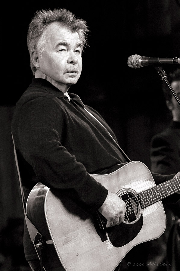 Black and White Photograph of John Prine playing guitar on stage at Merlefest in 2006
