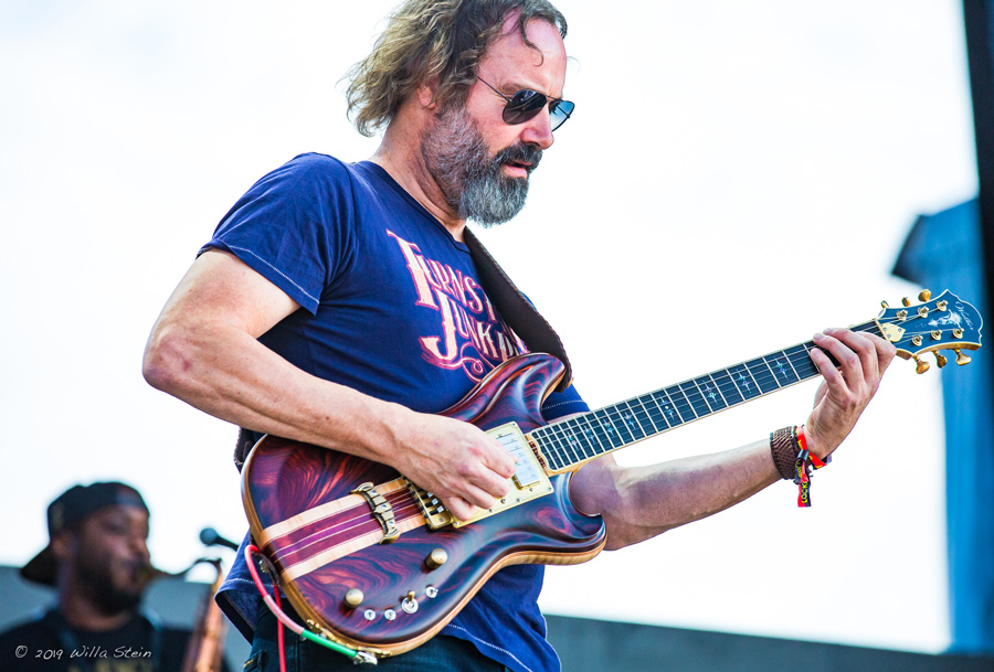 Color Photograph by Willa Stein of singer songwriter, guitarist, Neal Casal performing at The Lockn' Music festival in 2019