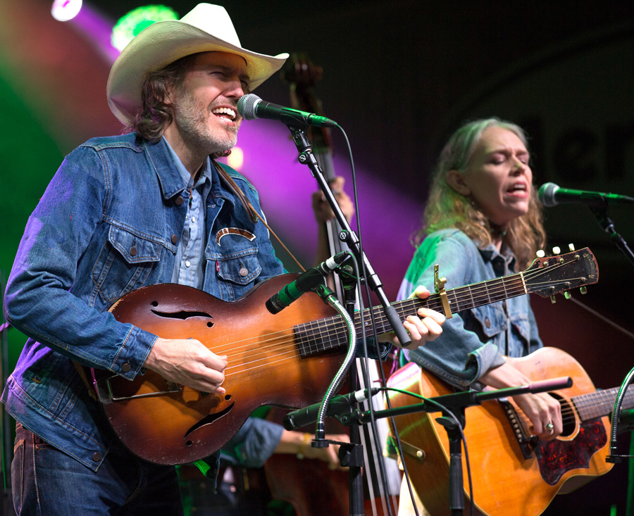 Color Photograph by Willa Stein of singer songwriters, David Rawlings and Gillian Welch performing, playing guitar at Merlefest