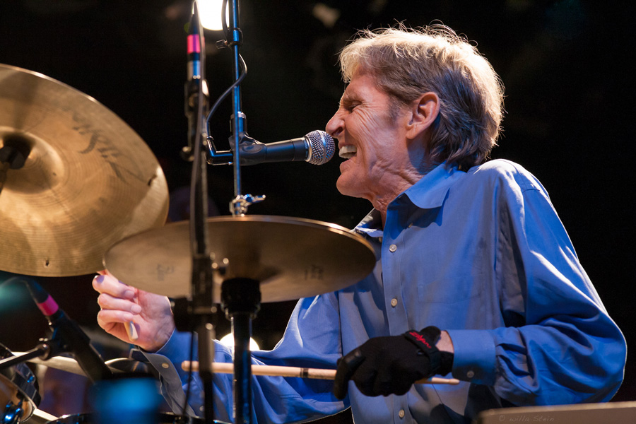 Color Photograph by Willa Stein of Levon Helm playing drums and singing on the Watson Stage at Merlefest in NC